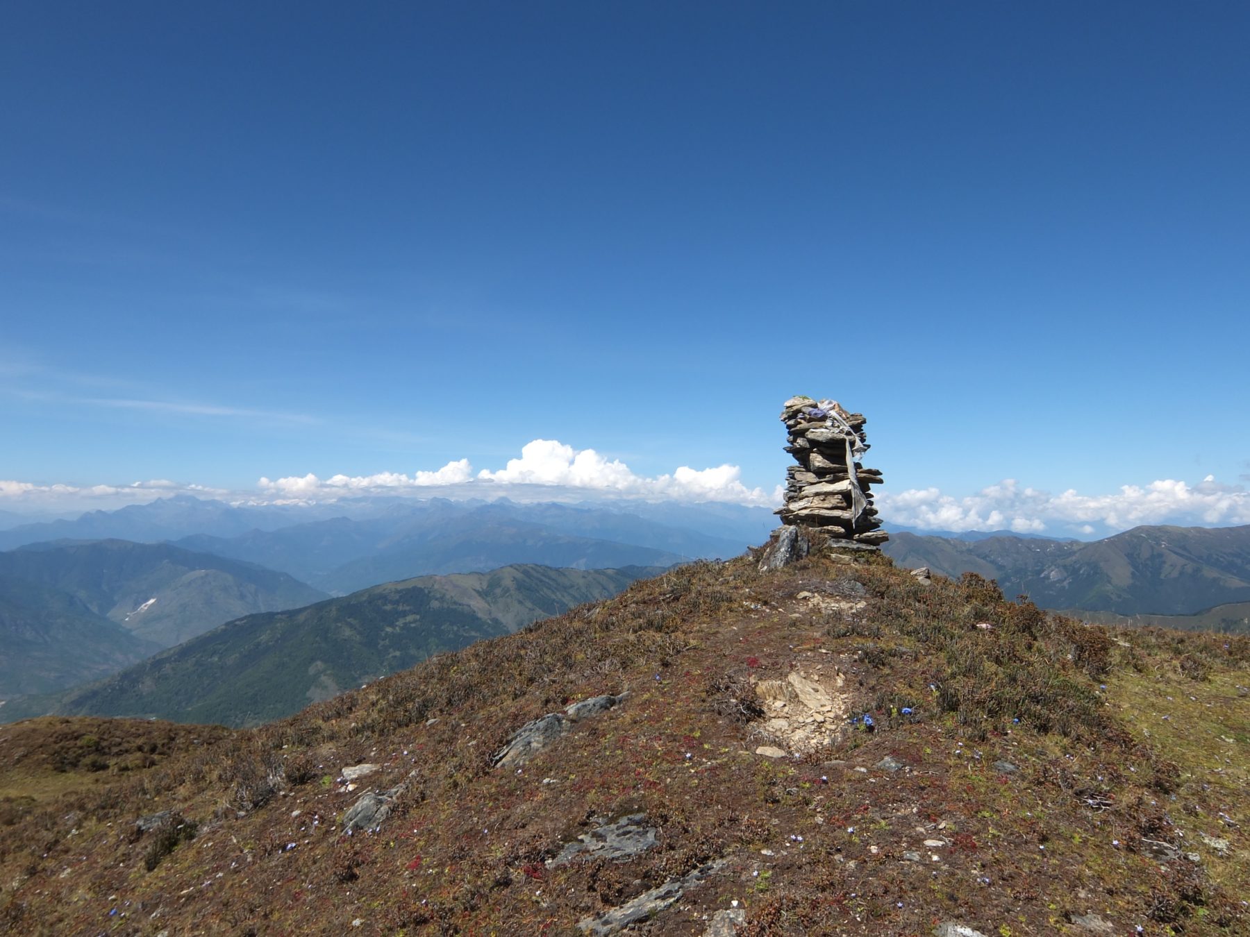 Bhutan Dagala Trek - The cairn at Pagalabtsa pass, 13,910 feet. For Buddhists, the construction of a cairn is a form of worship and a way to ask for good fortune. In Bhutan, you’ll find cairns covered in prayer flags, blessing the surrounding area and promoting peace. Bhutan Dagala Trek - The cairn at Pagalabtsa pass, 13,910 feet. For Buddhists, the construction of a cairn is a form of worship and a way to ask for good fortune. In Bhutan, you’ll find cairns covered in prayer flags, blessing the surrounding area and promoting peace.