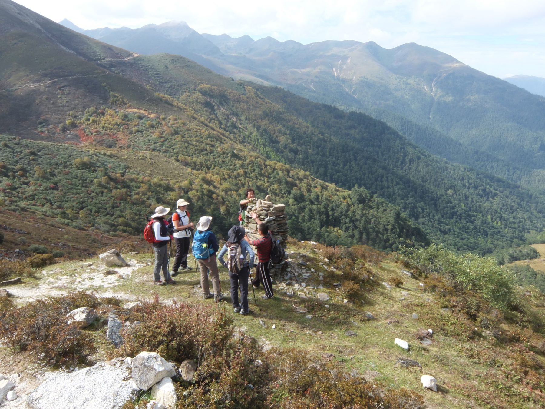 Bhutan Dagala Trek - Our guides add their stones to the final cairn on our trek. Bhutan Dagala Trek - Our guides add their stones to the final cairn on our trek.