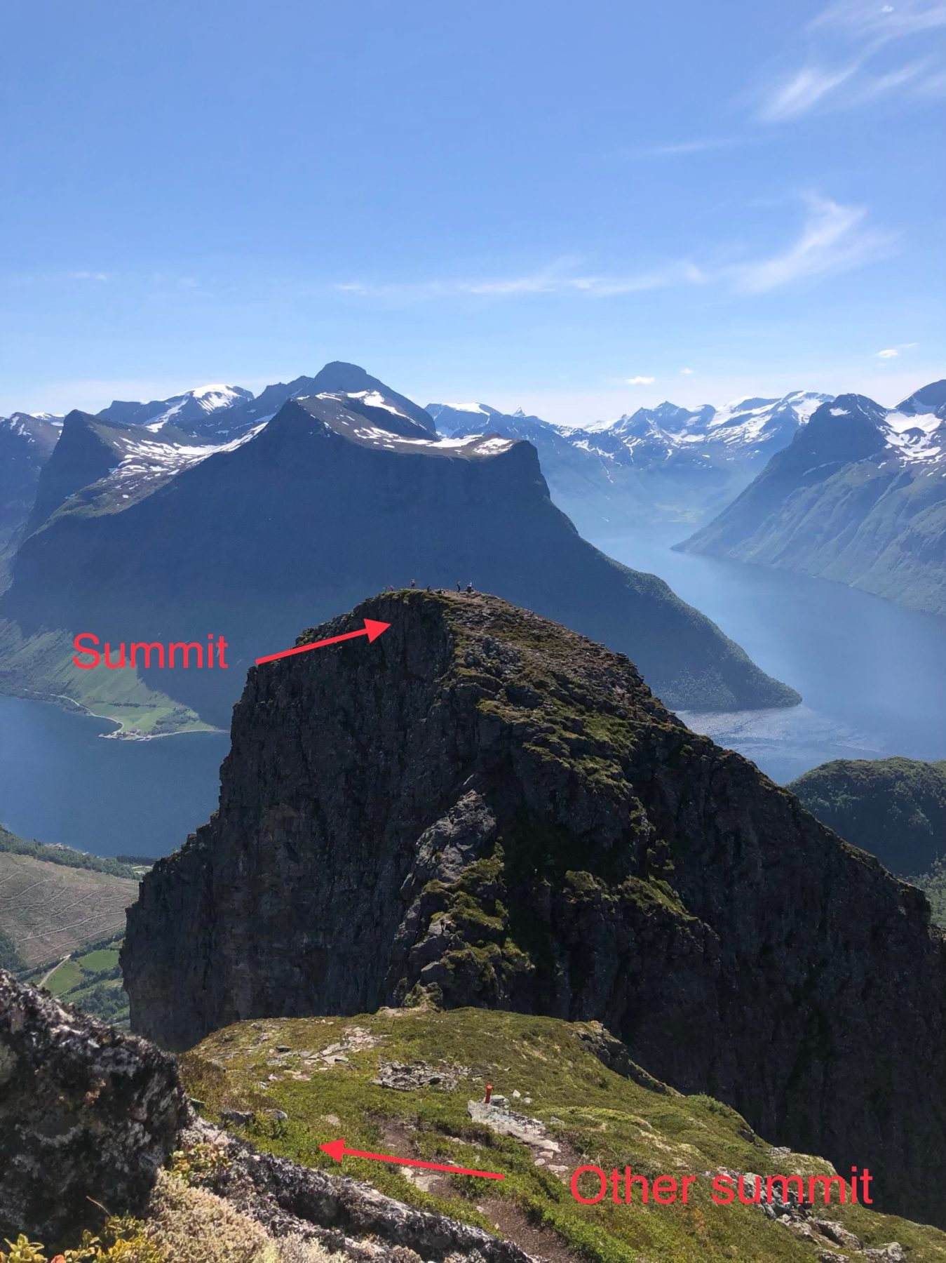 Norway - Just over the edge there is a cable handrail to help you access the saddle connecting the two peaks. Norway - Just over the edge there is a cable handrail to help you access the saddle connecting the two peaks.