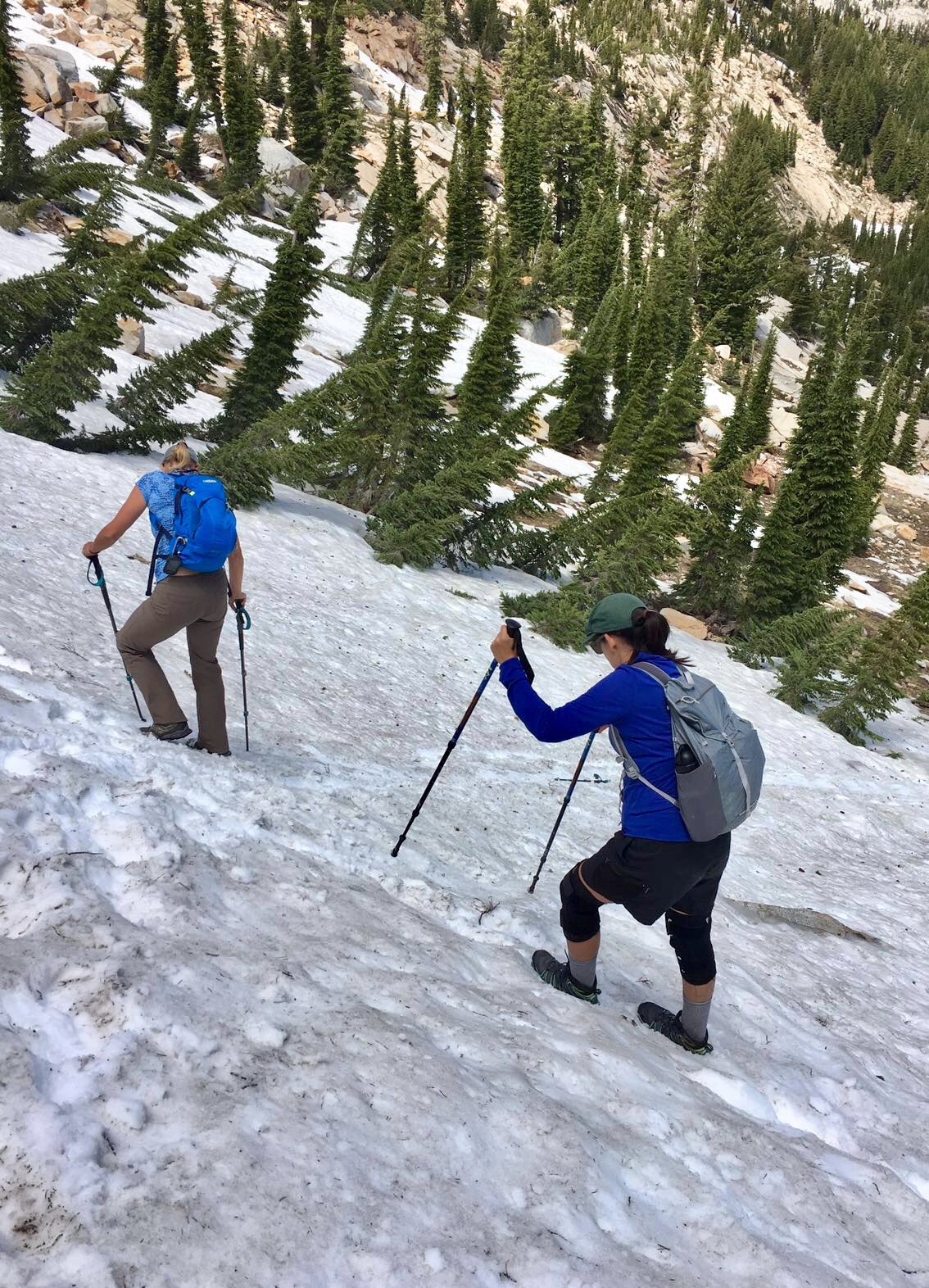 Desolation Wilderness California - We knew it would be unwise to navigate down this steep snow-covered slope, and started a gradual traverse with eyes on the dry rocky path just across, but a missed step had some of us glissading down instead. Desolation Wilderness California - We knew it would be unwise to navigate down this steep snow-covered slope, and started a gradual traverse with eyes on the dry rocky path just across, but a missed step had some of us glissading down instead.