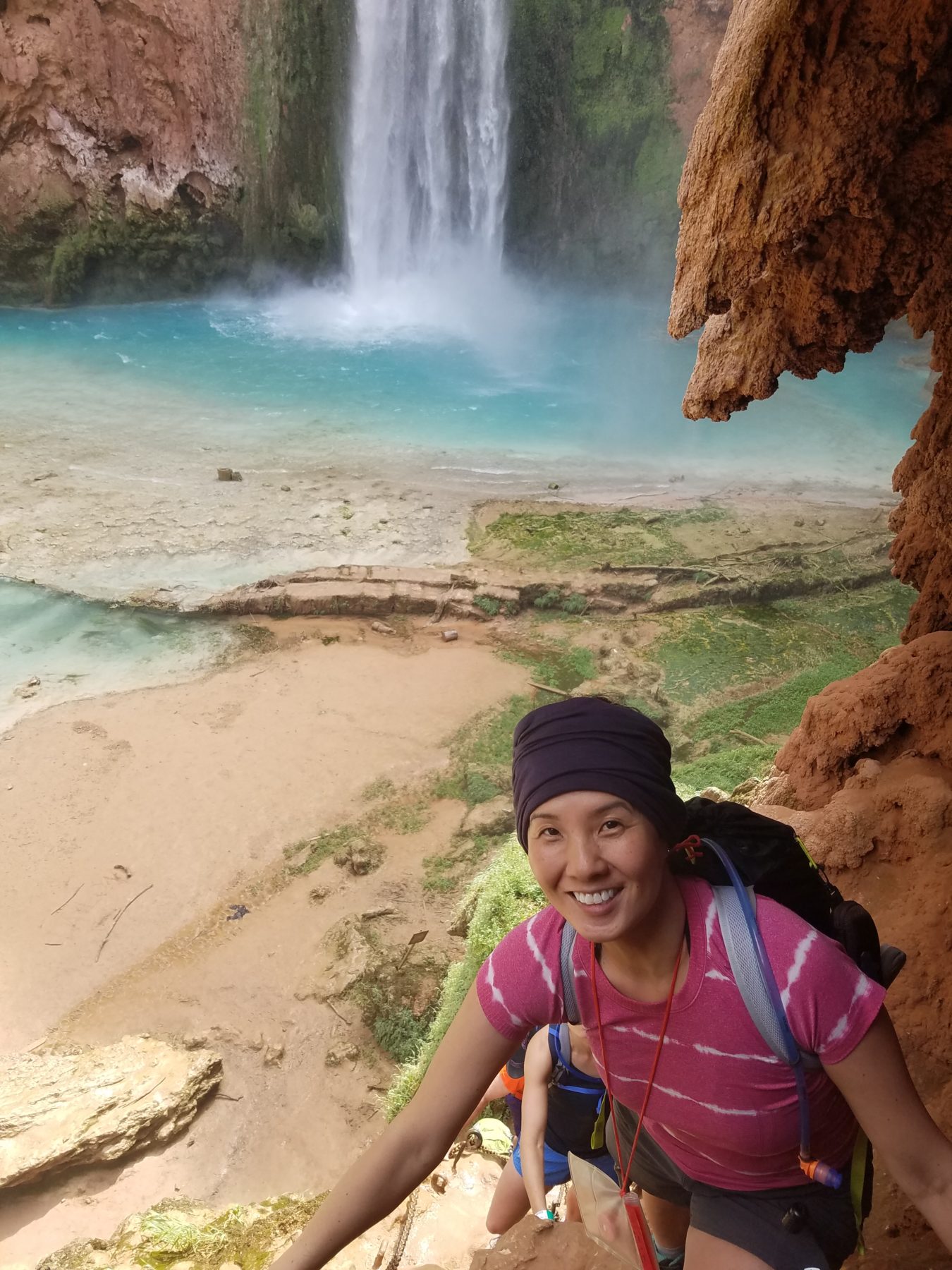 Havasupai - Jenny making her way down the chain ladders to the base of Mooney Falls. Havasupai - Jenny making her way down the chain ladders to the base of Mooney Falls.