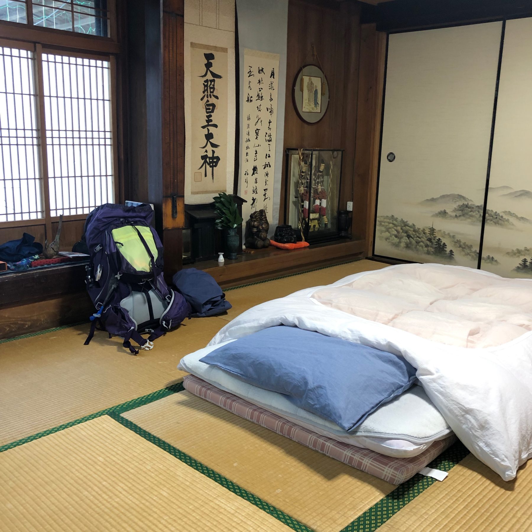 Kumano Kodo, Japan - Our homestay (minshuku) in that village with no amenities was the nicest place we stayed, confirming our bias that the most worthwhile places to visit require significant effort to reach. .Blissfully quiet, our comfy, clean tatami rooms opened to a courtyard lush with flowers and a water wheel fountain. To get there from the trailhead the host drove us down a riverbank, across, through, and along the river on a not-road, to their tiny hamlet of three homes with extensive gardens, chicken coops, and a helipad. I asked what the helipad was for and our host-mama-san replied: medical help. You may have noticed we are very remote here. Kumano Kodo, Japan - Our homestay (minshuku) in that village with no amenities was the nicest place we stayed, confirming our bias that the most worthwhile places to visit require significant effort to reach. .Blissfully quiet, our comfy, clean tatami rooms opened to a courtyard lush with flowers and a water wheel fountain. To get there from the trailhead the host drove us down a riverbank, across, through, and along the river on a not-road, to their tiny hamlet of three homes with extensive gardens, chicken coops, and a helipad. I asked what the helipad was for and our host-mama-san replied: medical help. You may have noticed we are very remote here.